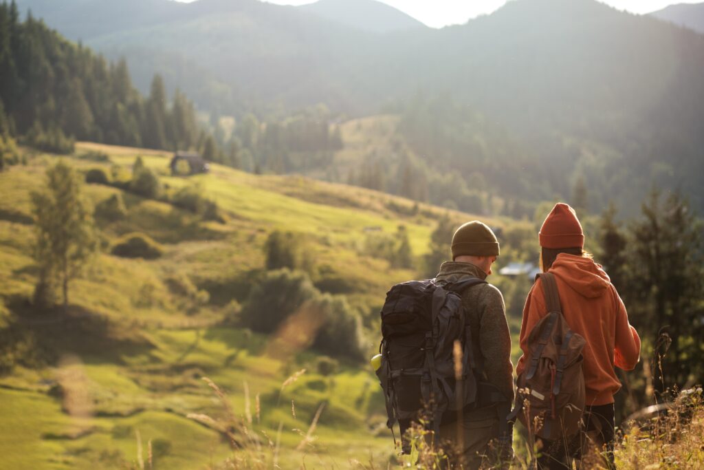 Two people trekking through the countryside